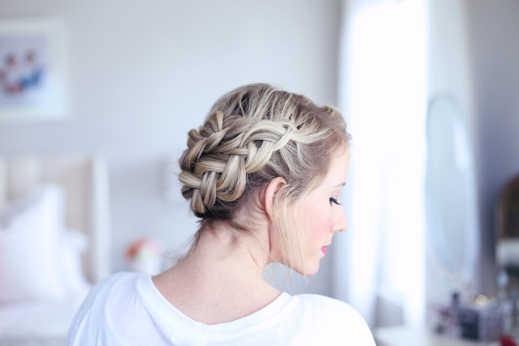 Profile side view of young women standing in her room modeling "Crown Braid" hairstyle
