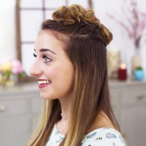 Side view of a girl smiling sitting in her room modeling "Triple Top Knot" hairstyle