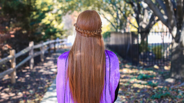 back view of woman with long red hair and back braid