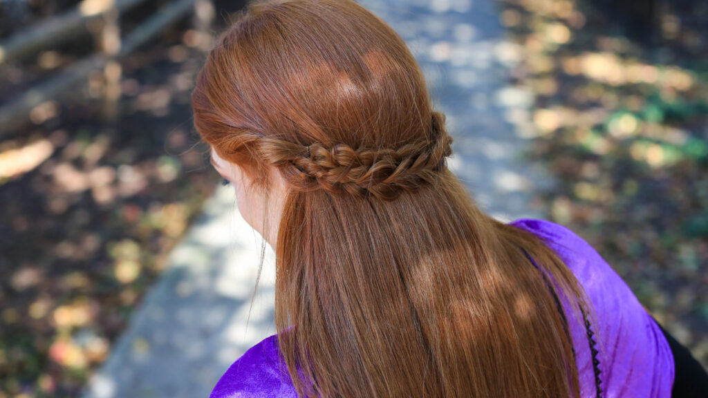 Back view of long hair woman with Frozen inspired back braid hairstyle.