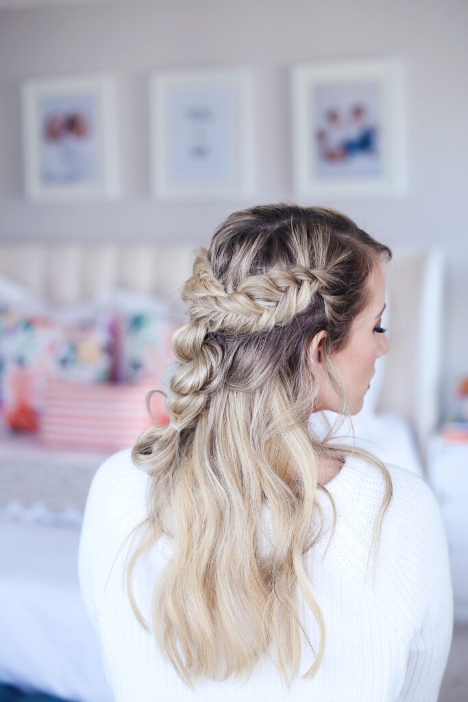 Side view of young woman standing in her room wearing a white shirt modeling "Mixed Braid Half Up" hairstyle