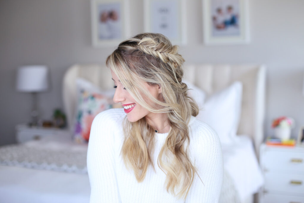 Profile of a young smiling woman sitting in her room modeling "Mixed Braid Half Up" Hairstyle