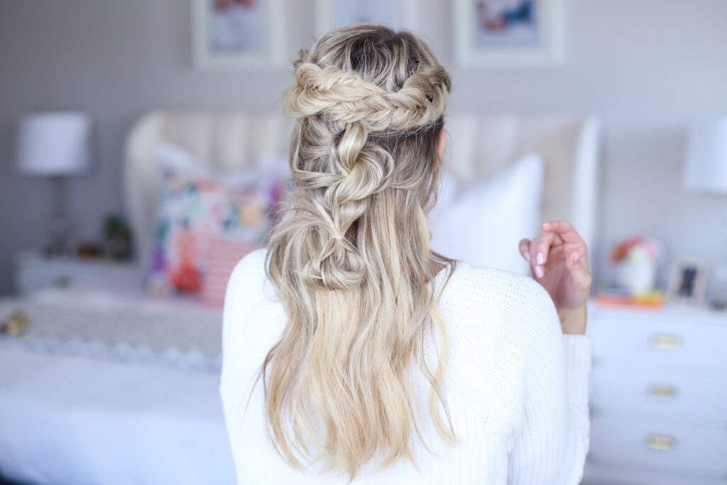 Back view of young woman standing in her room wearing a white shirt modeling "Mixed Braid Half Up" hairstyle