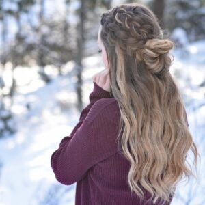 Back view of girl standing outside in a snowy forest modeling the "Double Dutch Half-Up" hairstyle
