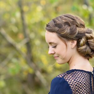 Side view of girl standing outside modeling the "French Braid Updo" hairstyle