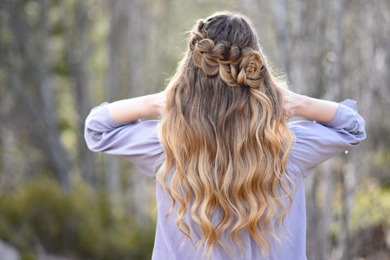 Back view of girl with long hair outside by trees modeling a Lace Pull Thru Rosette Bun