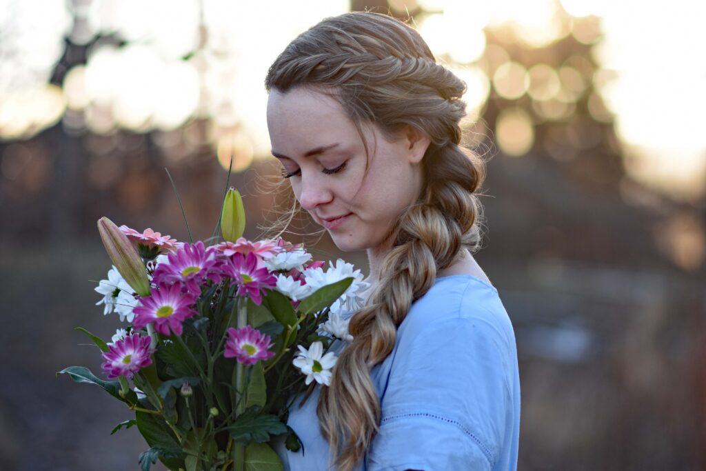 Profile view of a young girls holding flower bouquet