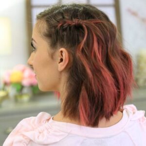 Side view with pink dyed hair indoors to modeling "Side Pull Back" hairstyle.