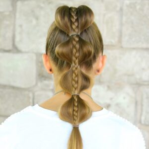 Back view of girl with white shirt standing outside modeling "Stacked Bubble Braid" hairstyle