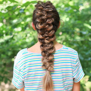 back view of girl with striped shirt standing outside modeling the "CGH Wrap Braid" hairstyle