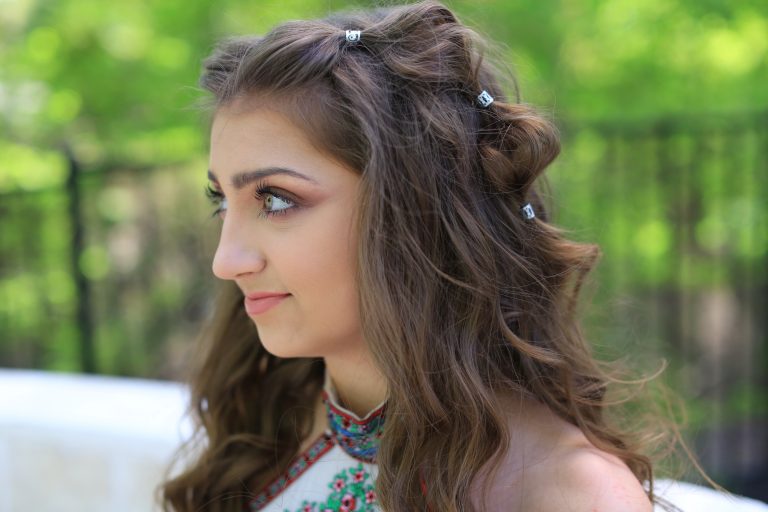 Side view of girl with long hair smiling while standing outside modeling "Boho Bubble Braids" hairstyle