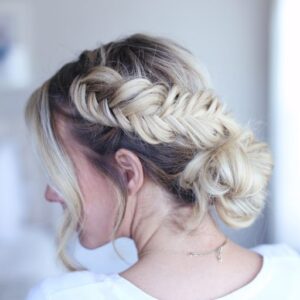 Side view of young woman standing in her room wearing a white shirt modeling "Fancy Fishtail Updo" hairstyle
