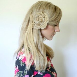 Profile of young blonde woman wearing a floral shirt modeling "Flower Braid Bun" hairstyle
