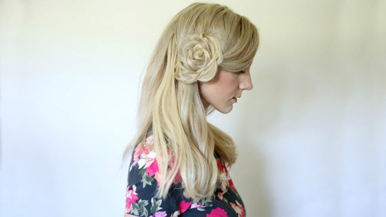 Profile of young blonde woman wearing a floral shirt modeling "Flower Braid Bun" hairstyle