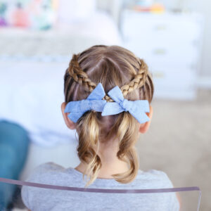 Back view of little girl sitting in her room modeling "Criss Cross Pigtails" hairstyle