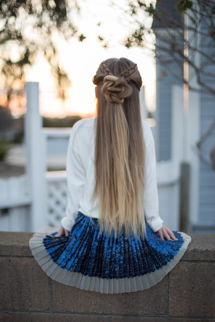 Back view of a young girl outside modeling cute "Braided Bun Combo" hairstyle