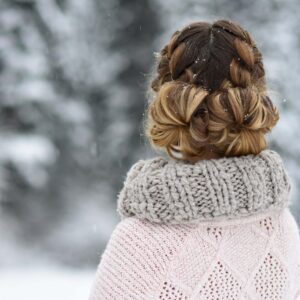 back view of girl standing outside in the snow while modeling " Double French Buns" hairstyle.