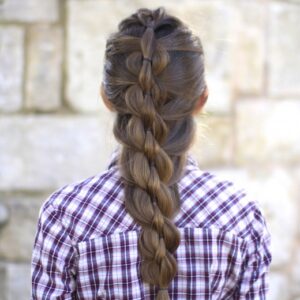 Back view of girl with purple shirt standing outside modeling "Pull-Through Mermaid Braid" hairstyle