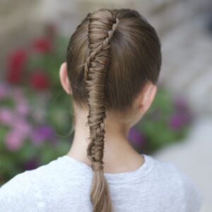 Young girl outside modeling Chinese Staircase Braid (back)