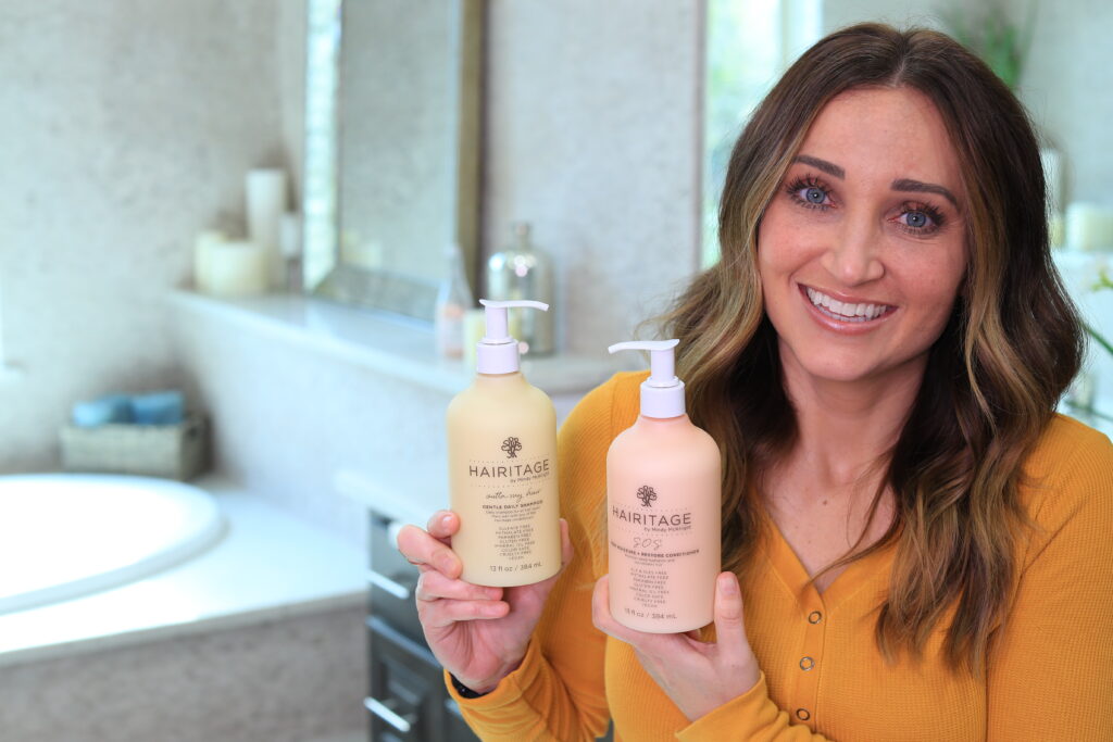 Women sitting in the bathroom holding a shampoo bottle and a conditioner