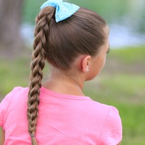 Little girl outside wearing a pink shirt modeling 3D Split Braid