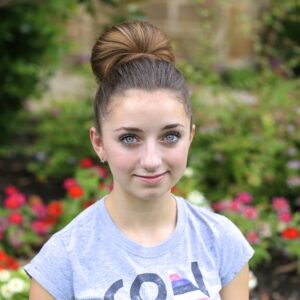 Portrait of a young girl modeling The Fan Bun | Prom Updos