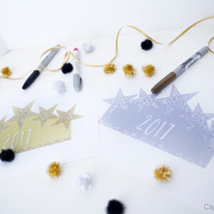 An assortment of crafts and markers in gold, silver, and black colors