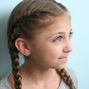 Portrait view of young girl modeling the Primrose Everdeen Braids | Hunger Games Hairstyles