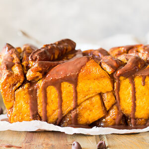 This Pumpkin Pull Apart Bread is full of warm pumpkin spice, sweet brown sugar and drizzled with a chocolate ganache!