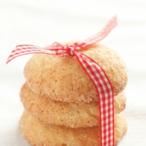 Three stacked snickerdoodle cookies and tied with a picnic pattern ribbon