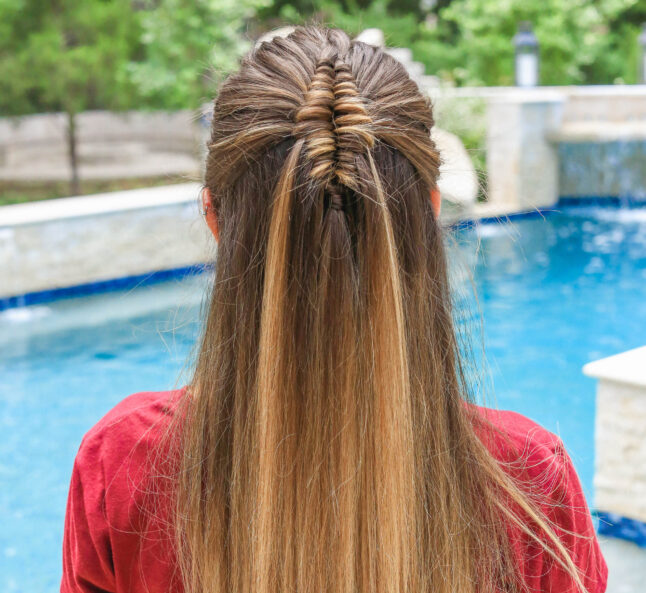 up close view of girl by the pool with long hair and showcasing long infinity braid