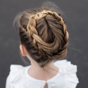 Top view of a little girl wearing a white shirt modeling "Halo Braid" hairstyle