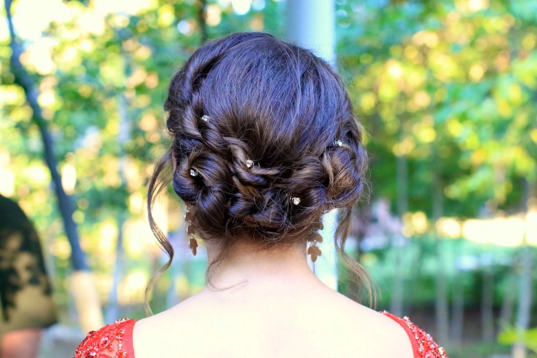Back view of girl standing outside modeling "Rope Twist Updo" hairstyle.