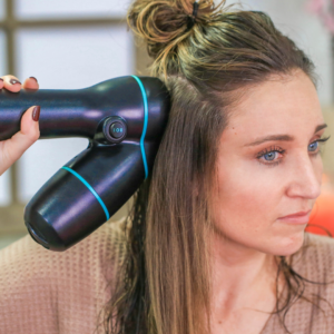 Woman using hair product, "RevAir" to style her hair