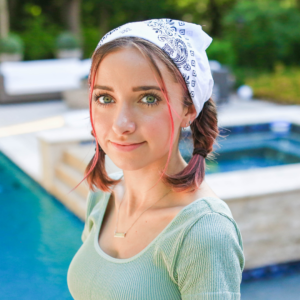 Image of young girl standing by the pool