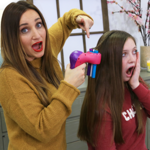 Mom styling her daughters hair while appearing shocked